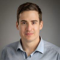 Bryan R. Goldsmith, Associate Professor of Chemical Engineering, wearing a blue and white micro-patterned button-down shirt.