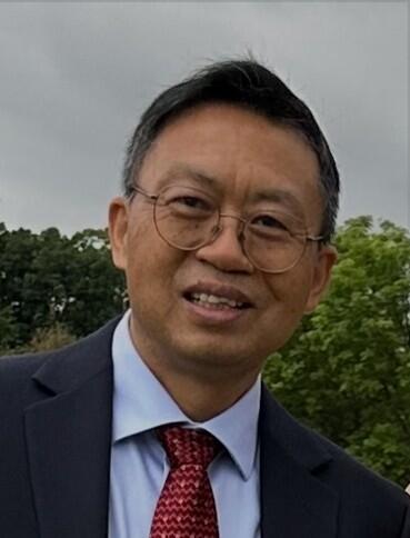 Headshot of Jianzhong Wu, Professor in the Department of Chemical and Environmental Engineering at UC Riverside, smiling and wearing a suit and tie outdoors.